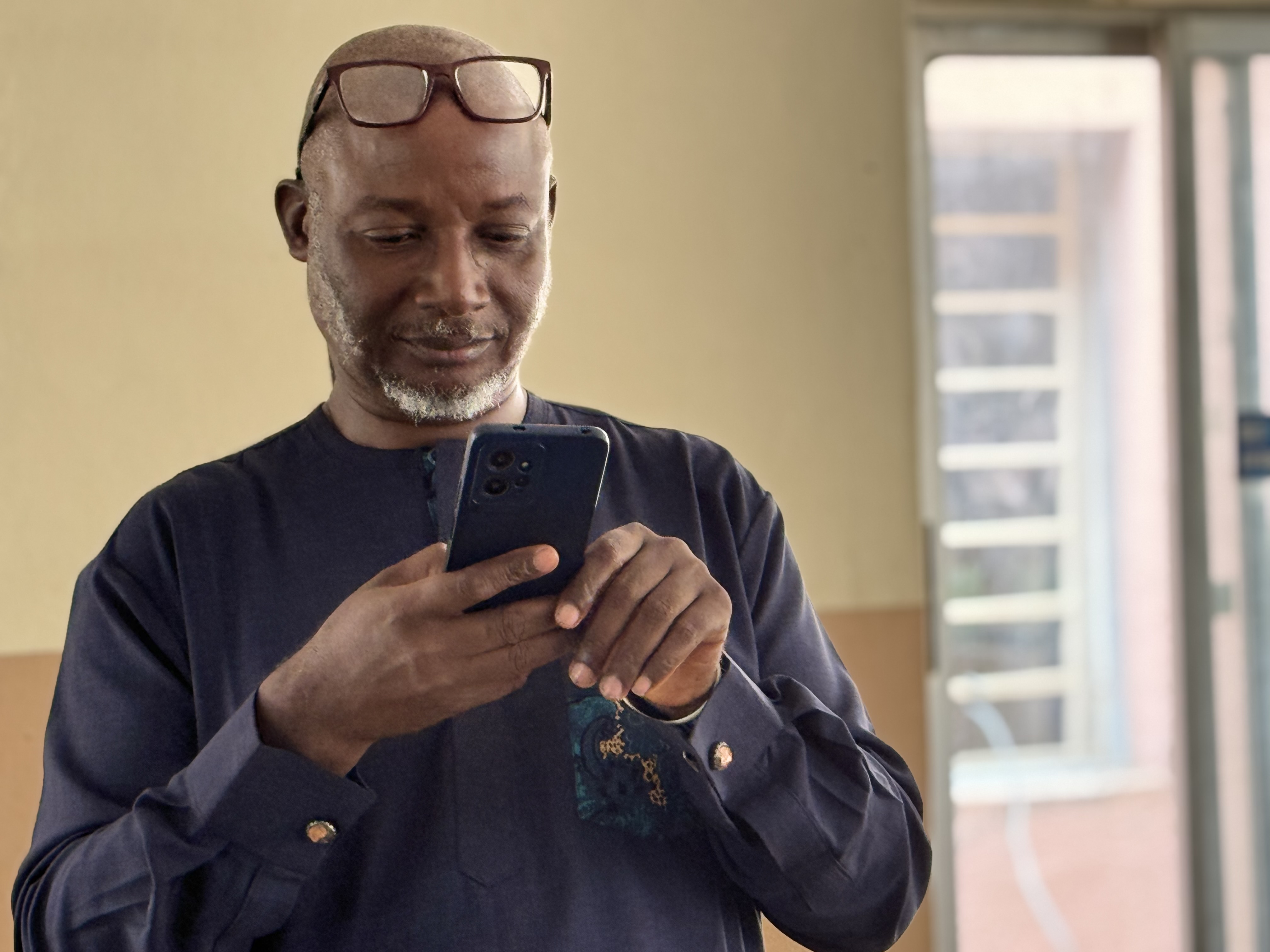 A workshop facilitator checking his phone between sessions