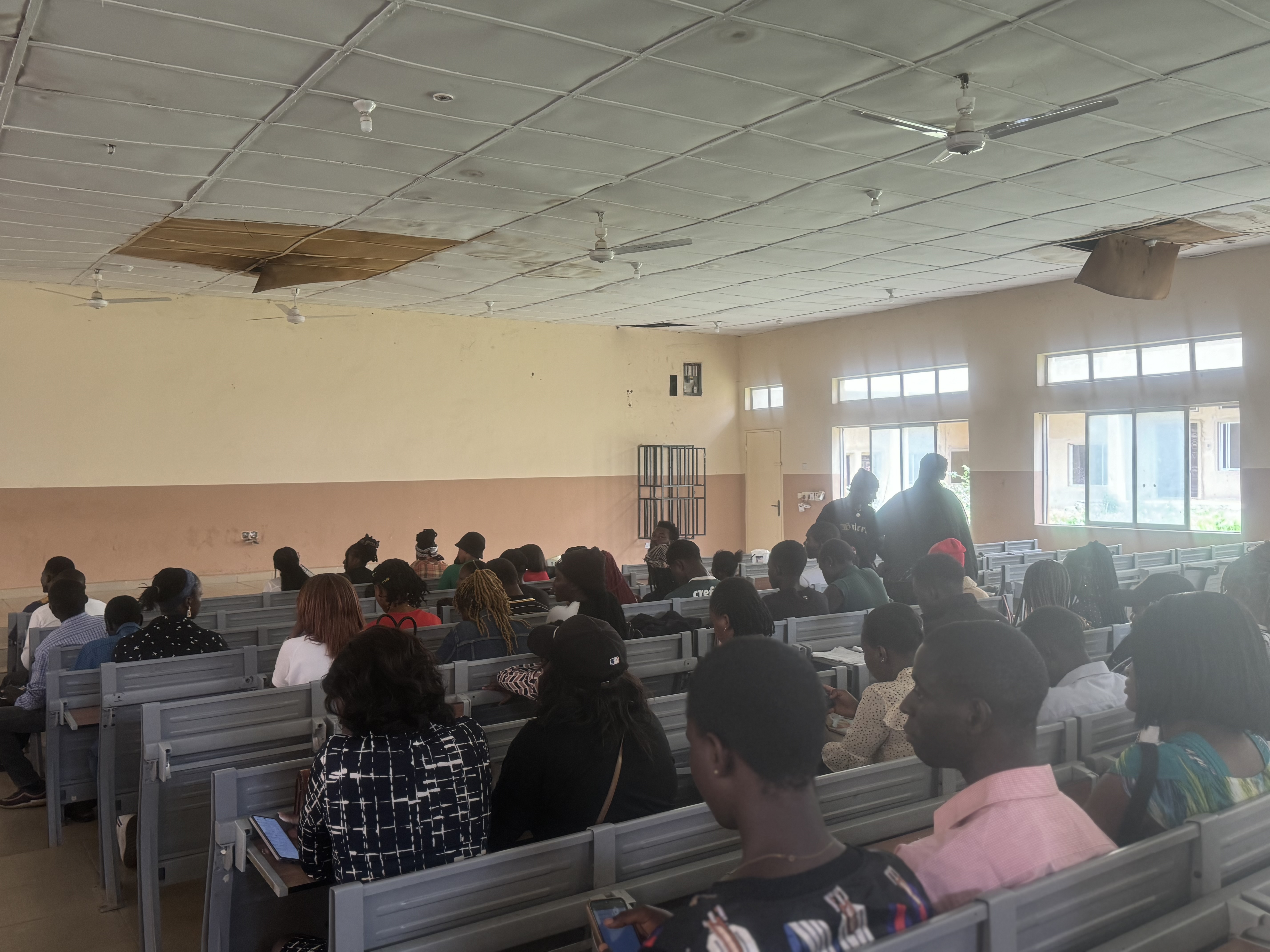 Students attending a playwriting lecture in a university hall