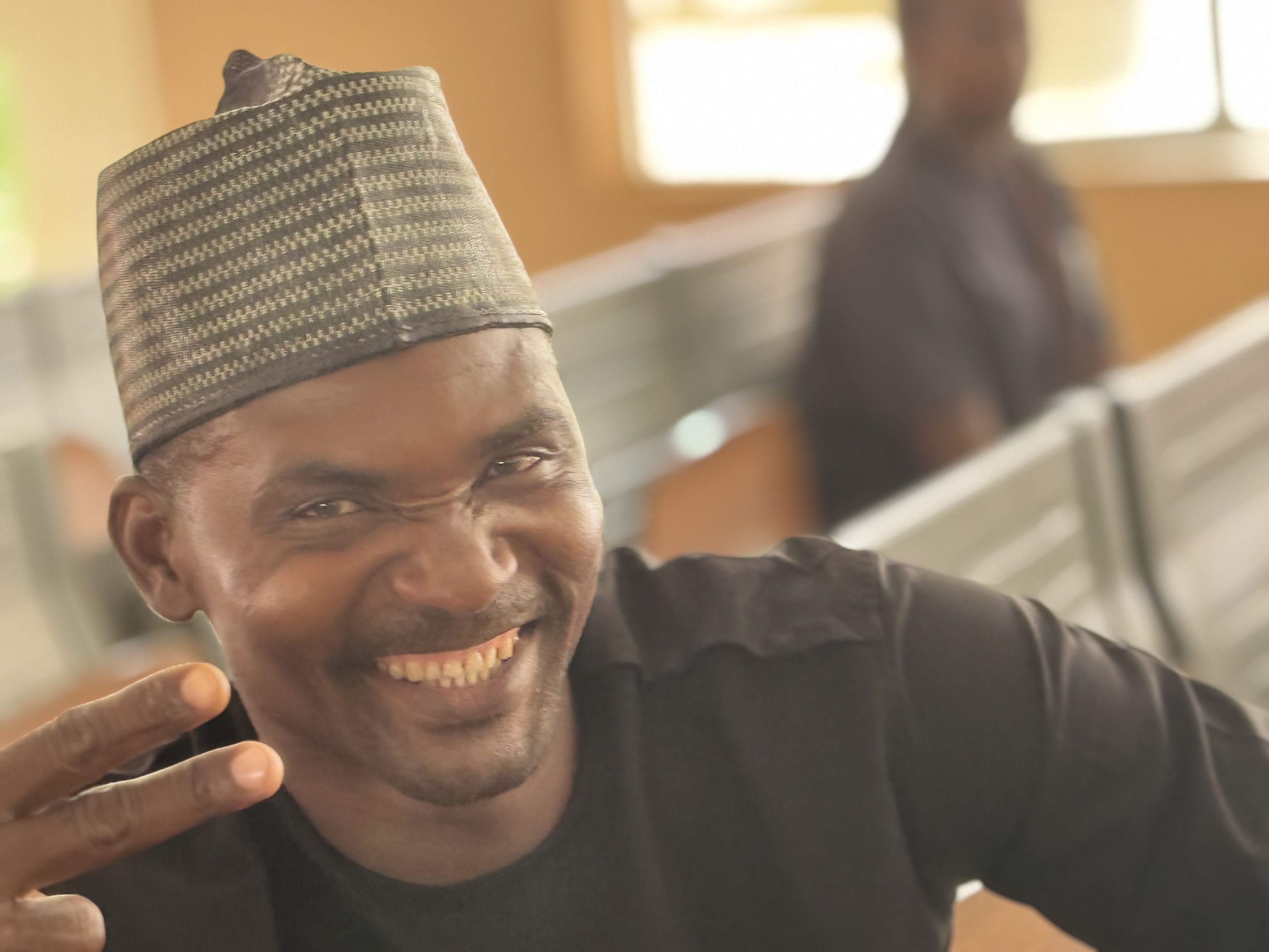 Paul Ugbede smiling at a workshop venue